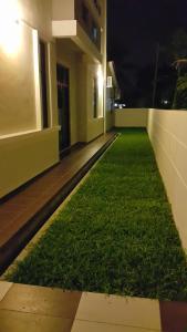 a room with grass on the side of a building at Woon Homestay in Balik Pulau +5 photos