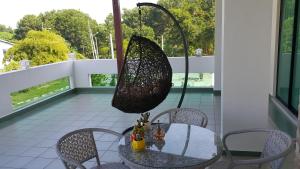 a net hanging from a table on a balcony at Woon Homestay in Balik Pulau