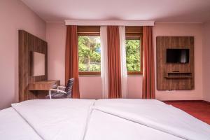 Televízia a/alebo spoločenská miestnosť v ubytovaní B&B Villa Angy