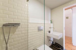 a bathroom with a toilet and a sink at LovelyStay - Cativo Mezzanine Studio in Porto
