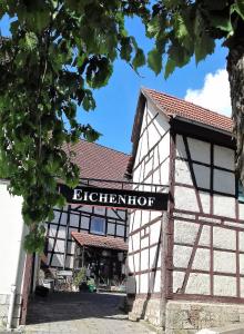 a building with a sign on the front of it at Hotel Bad Langensalza Eichenhof in Bad Langensalza