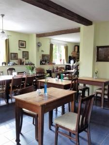 a dining room with wooden tables and chairs at Hotel Bad Langensalza Eichenhof in Bad Langensalza