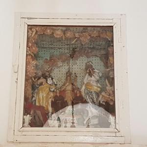 a painting in a white frame on a wall at Trulli Dal Conte in Locorotondo