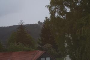 a castle on top of a hill with trees at Pension Burgblick in Nordstemmen