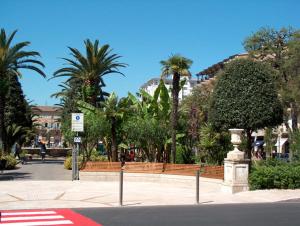 a city street with palm trees and a street sign at Bed & Breakfast Bompadre in Civitanova Marche