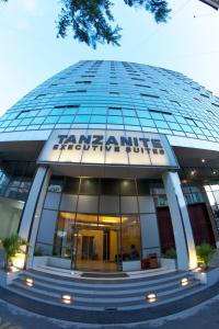 a large building with a clock on the front of it at Tanzanite Executive Suites in Dar es Salaam