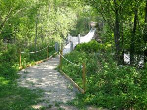 a trail with a rope fence and a bridge at Storjord Hotel in Storjord