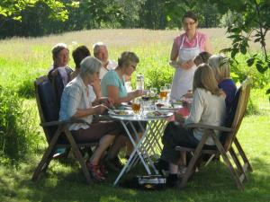 a group of people sitting around a table at Storjord Hotel in Storjord