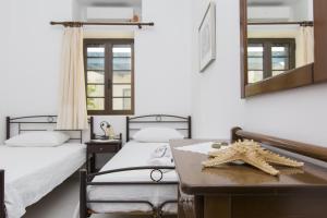 a room with two beds and a starfish on a table at Moutsouna Beach in Moutsouna Naxos