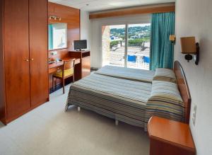 Postel nebo postele na pokoji v ubytování Hotel Port-Bo + 24 fotografií