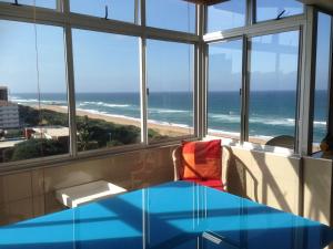 a room with a view of the beach and the ocean at Seaview Apartment Amanzimtoti in Amanzimtoti