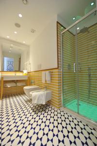 een badkamer met een douche, een toilet en een wastafel bij Maison Lauren in Sorrento