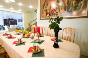 a table with candles and plates of food on it at VGH accommodation services in Vilnius