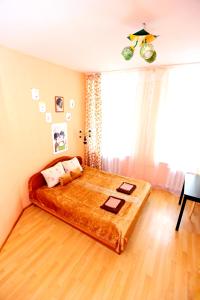 a bedroom with a large bed in front of a window at MANGO SPb in Saint Petersburg