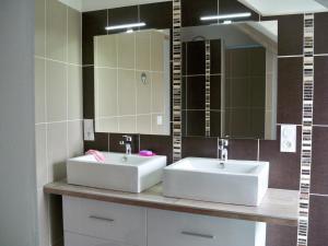 a bathroom with two sinks and a mirror at Gite de La Caminais in Pleurtuit