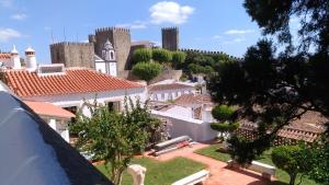 a view of a town with buildings and trees at Casa da Talhada - Stone House in Óbidos