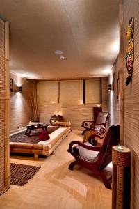 a room with a bed and a couch and chairs at Chaika Beach Resort in Sunny Beach