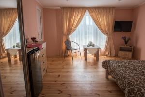 a bedroom with a bed and a table and a window at Alkatraz in Gribovka