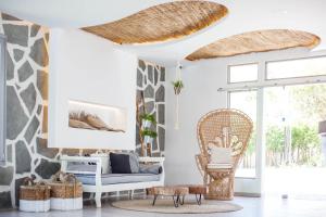 a living room with a couch and a chair at Malibu Boutique Studios & Bungalows in Faliraki
