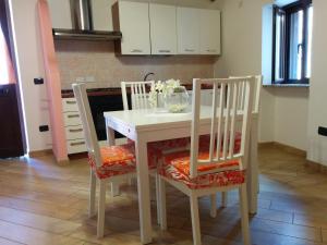 a white table and chairs with flowers on top of it at Casa Delle Rose in Capaccio-Paestum