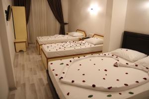 A bed or beds in a room at Dostlar Hotel