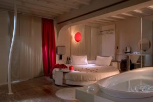 a bathroom with a bed and a tub in a room at SuiteSistina for Brave Lovers in Rome