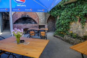 a patio with tables and chairs and a brick fireplace at Alkatraz in Gribovka
