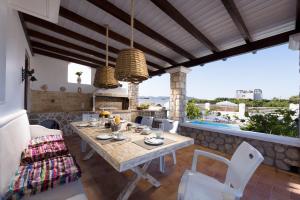 a patio with a table and chairs and a pool at Villa Dimitra Gennadi in Gennadi