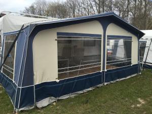 a blue and white tent in the grass at Irjados-surf in Chałupy