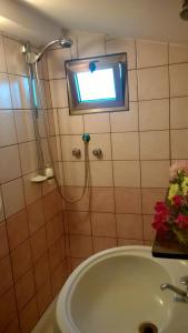 a bathroom with a tub and a shower and a window at Camping Dell'Uva in Le Castella