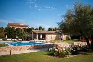 a villa with a swimming pool in a yard at Hotel Ca'n Bonico in Ses Salines