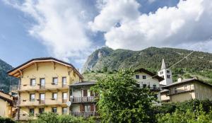 a group of buildings in front of a mountain at La Maison de Franco in Valpelline