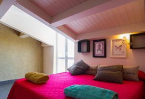 a bedroom with a large bed with a red blanket at B&B Casa Liuzza in Santa Teresa di Riva