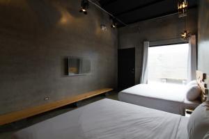Postel nebo postele na pokoji v ubytování Kenting Xia Ye B&B