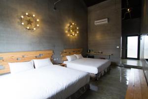Postel nebo postele na pokoji v ubytování Kenting Xia Ye B&B