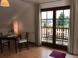 a dining room with a table and a balcony at Lokal Genial Pension & Restaurant in Beelitz +14 photos