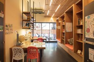 a room with a table and chairs in a room at On My Way - Taipei Hostel in Taipei
