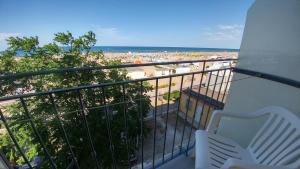 a balcony with a view of the beach at Hotel Capitol in Rimini