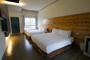 Postel nebo postele na pokoji v ubytování Kenting Xia Ye B&B