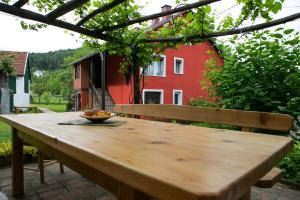 a wooden table with a bowl of fruit on it at Holiday Home Modric in Otočac