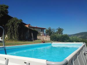 a swimming pool in front of a house at I Granai in Pontassieve