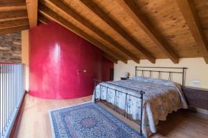 a bedroom with a bed and a red wall at Belvedere Apartments on Como Lake in Torno