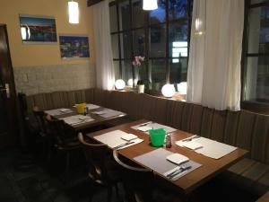 a dining room with tables and chairs in a restaurant at Motel Füssen im Allgäu in Füssen