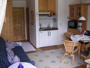 a living room with a kitchen and a table at Schatzberg-Haus Auffach in Auffach