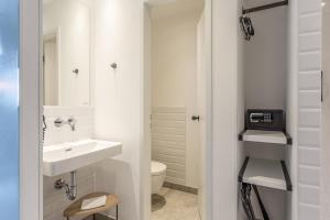 a bathroom with a sink and a toilet at gambino hotel CINCINNATI in Munich +49 photos