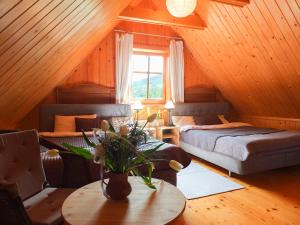 a bedroom with two beds and a table in a attic at Dom Rajka in Stronie Śląskie +37 photos