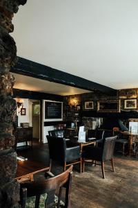 a restaurant with chairs and tables in a room at Rose And Crown in Porthcawl