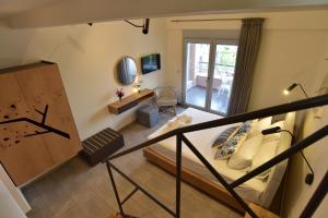 a small room with a bed and a balcony at Issalos Studios in Skala Potamias