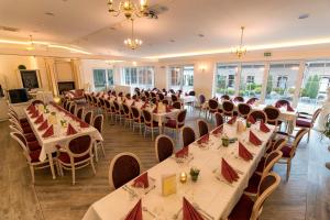 a banquet hall with tables and chairs in a room at Hotel Fürstenberger Hof in Xanten