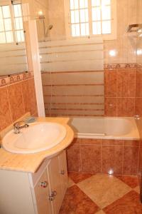 a bathroom with a sink and a shower and a tub at Casa Vega in Benidorm